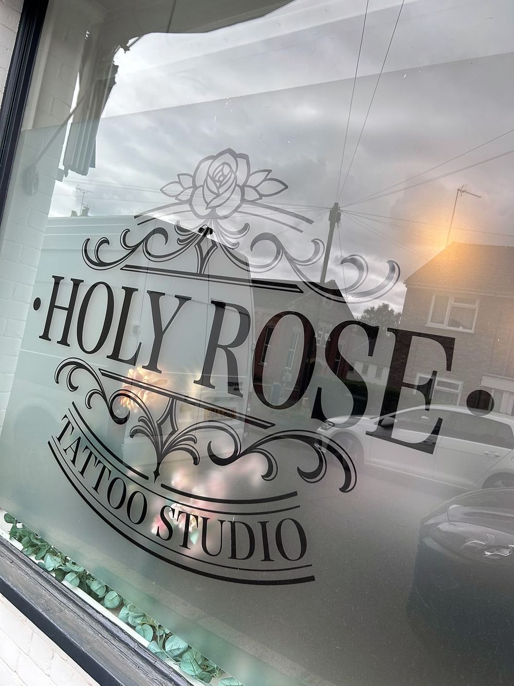 The Holy Rose Tattoo Studio window sign